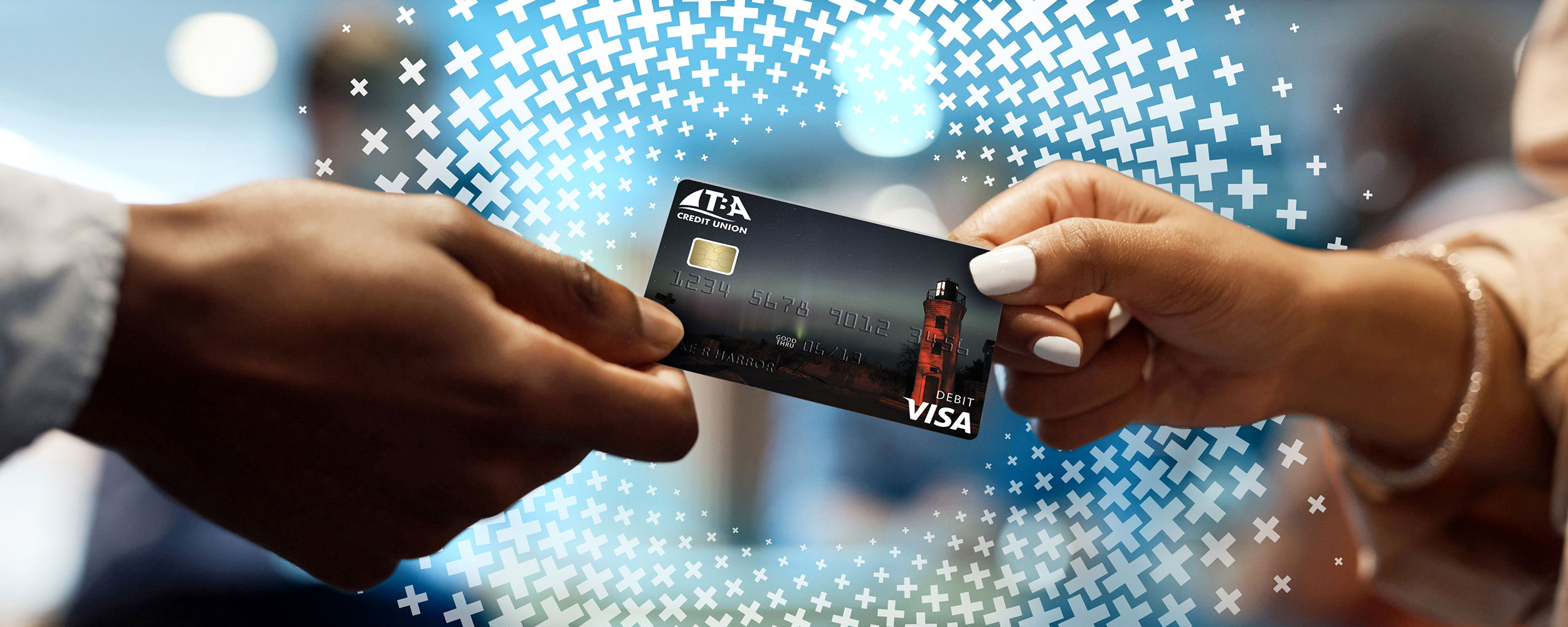A debit card changes hands between two people.