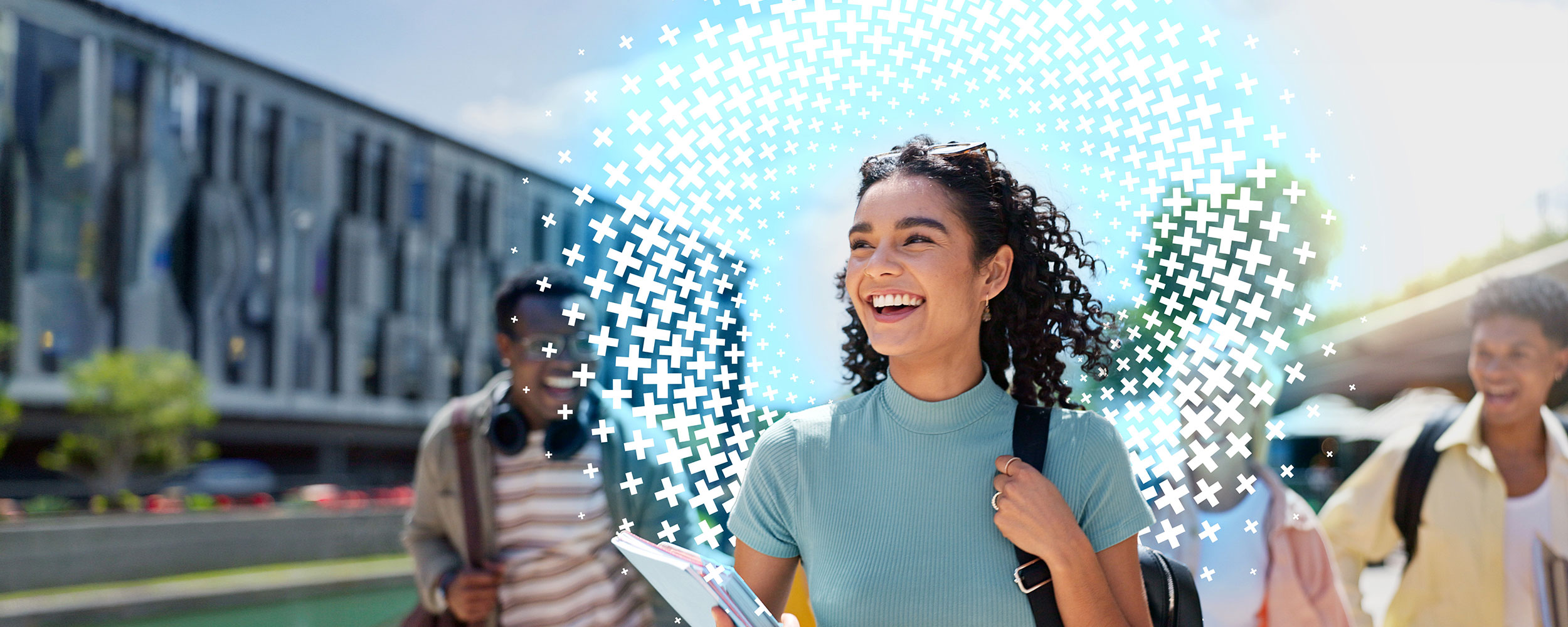 Woman smiling while walking on a college campus.