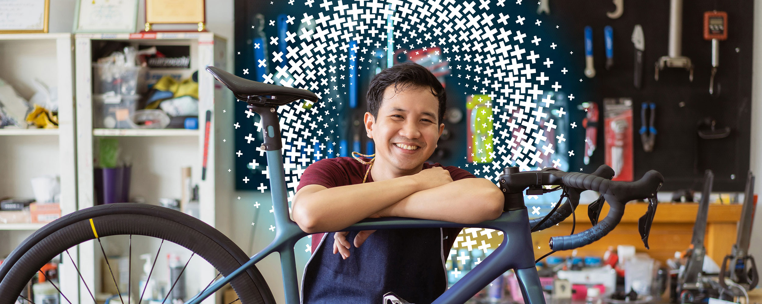 A small business owner smiling in his bike shop.