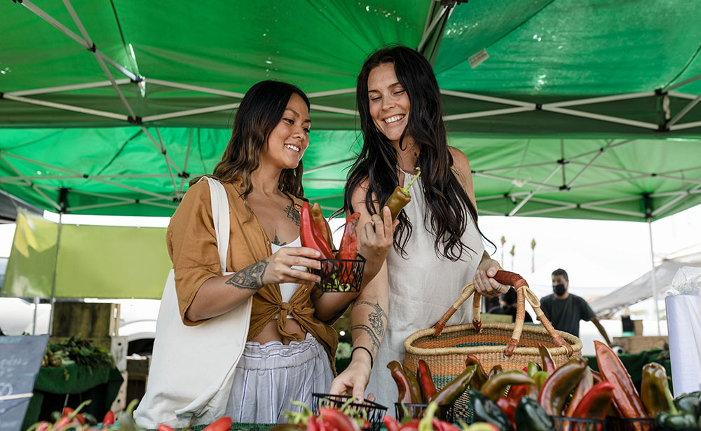 two women shopping at a farmers market