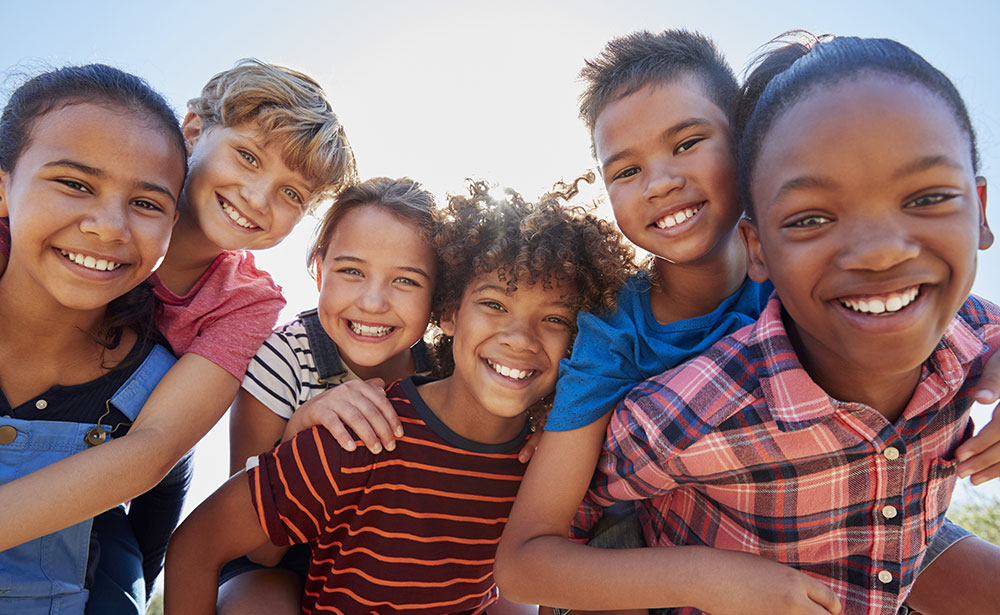 Close up photo of children gathered together