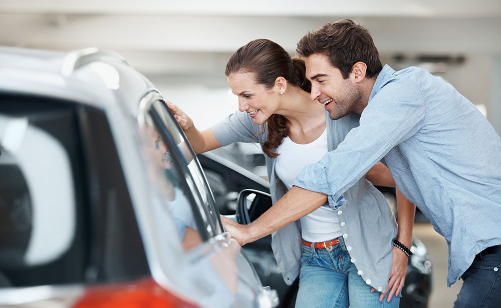 Young couple shopping for a new car