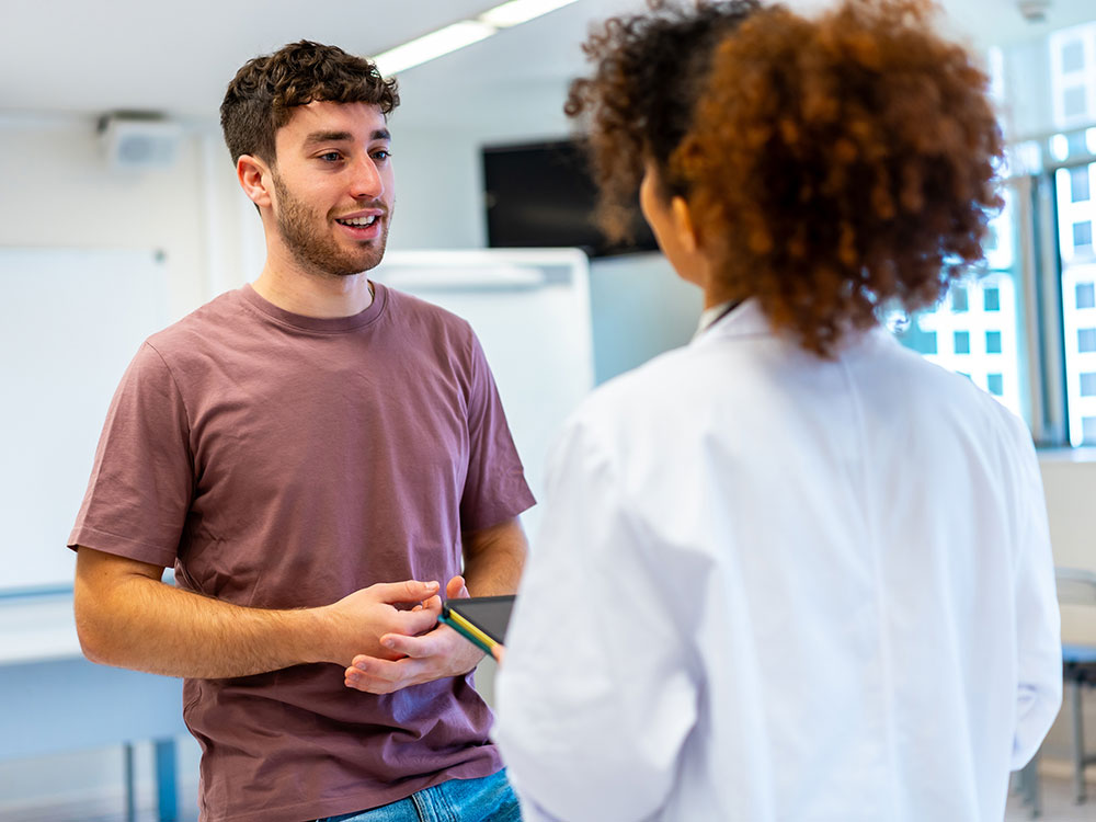 Young adult speaking with a professional during an in-person consultation.