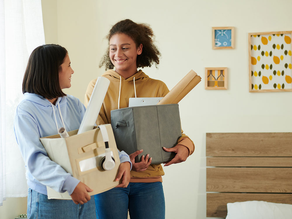 750-next-step-1413673442 Two students moving into a dorm-like apartment.