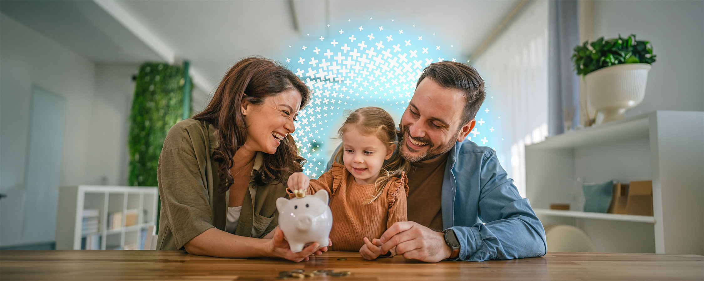 Parents watch their young child place a coin into a piggy bank at home.